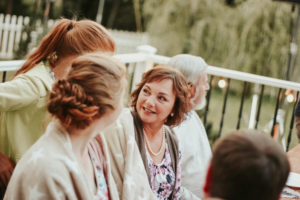 pexels-photo-3407978-3407978 Family enjoying a cozy outdoor summer gathering with smiles and conversations.